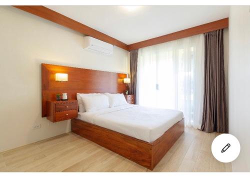 En eller flere senge i et værelse på Citi Di Mare Amalfi Cebu 2 BR condo