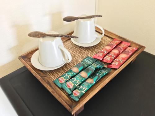 a tray with two cups and sugar packets on a table at Baan Dan Ta Wan Nuea in Chiang Mai