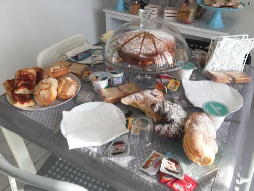 a table with a bunch of different types of pastries at Maison De luxe in Pompei
