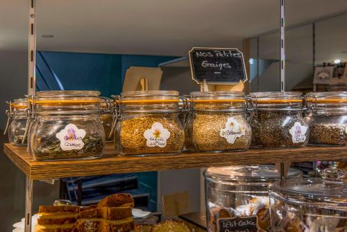a display of jars of food on a shelf at Hôtel Mercure Paris Suresnes Longchamp in Suresnes