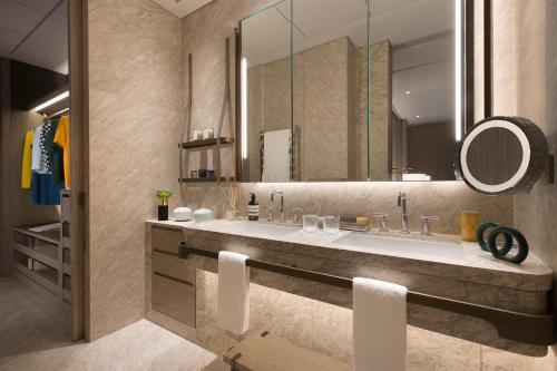 a bathroom with a large sink and a mirror at K11 ARTUS in Hong Kong