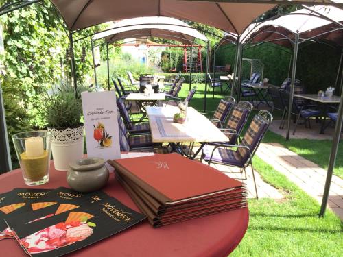 a table with a book sitting on top of it at Hotel Ebnet in Mutterstadt