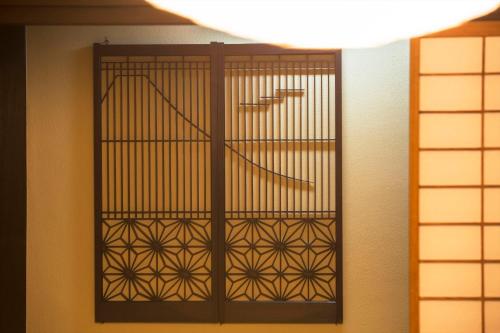 a door with a gate in a room at Ito Ryokuyu in Ito