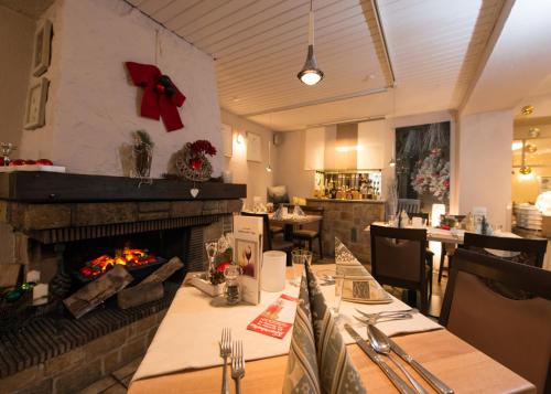 a dining room with a fireplace in a restaurant at Hotel Ebnet in Mutterstadt
