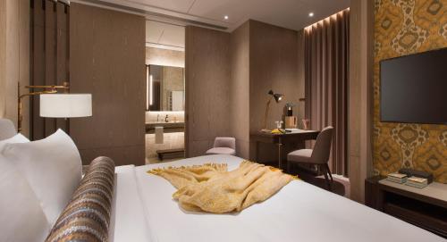 a hotel room with a bed and a television at K11 ARTUS in Hong Kong