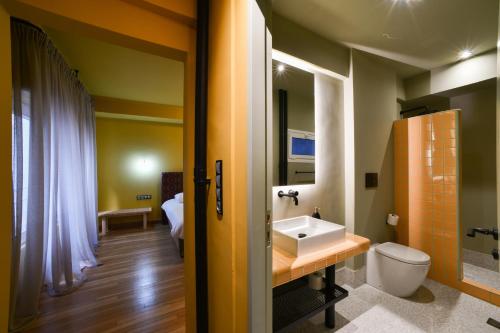 a bathroom with a sink and a toilet at Kolonaki Boutique Apartments by Olala Homes in Athens