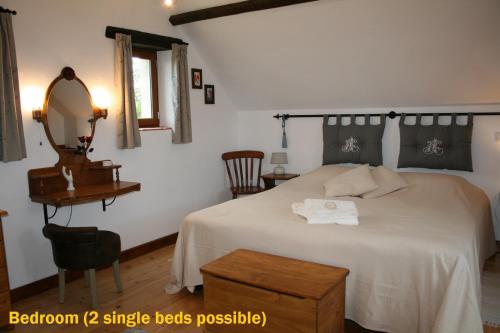a bedroom with a bed with a mirror and a table at Hillside Park Dordogne in Saint-Lazare