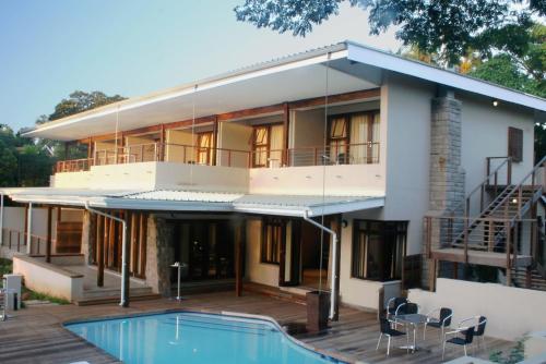a house with a swimming pool in front of it at One On Hely in Mtunzini