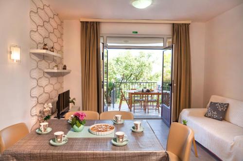a living room with a table and a couch at Apartment Villa Lidija in Lovran