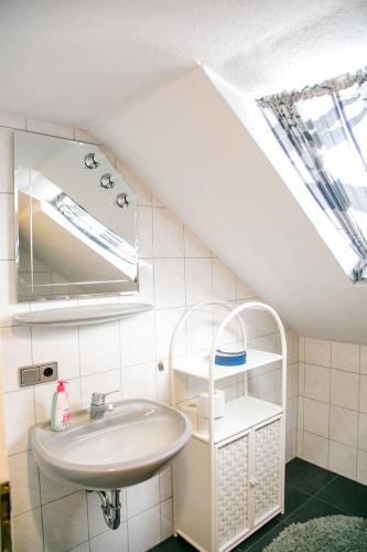a bathroom with a sink and a mirror at Hohes Ferienhaus in Heiligenstadt