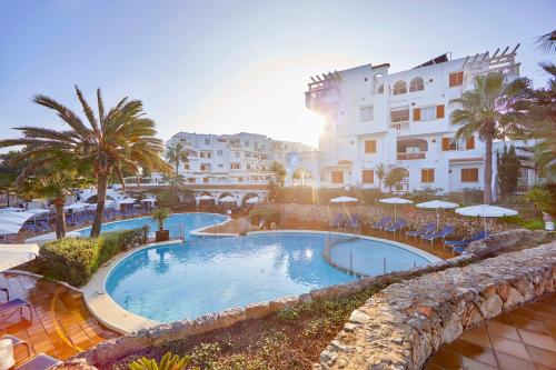 a large swimming pool in front of a building at Gavimar La Mirada Hotel and Apartments in Cala d´Or