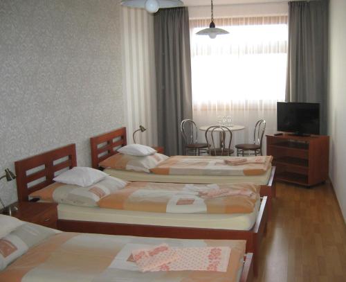 Postel nebo postele na pokoji v ubytování Penzion U Radnice