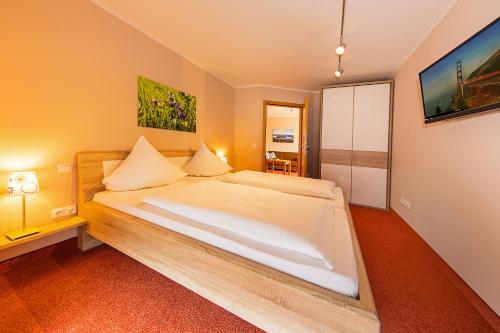a bedroom with a large bed in a room at Hotel Haus Seeblick in Nideggen