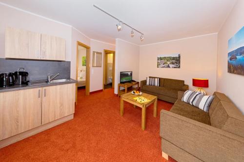 a living room with a couch and a table at Hotel Haus Seeblick in Nideggen
