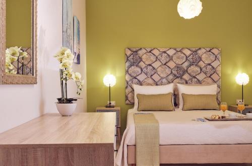 a bedroom with a bed with a table and two lamps at La Palma Apartments - 2km from Zakynthos Town, by ZanteWize in Zakynthos Town