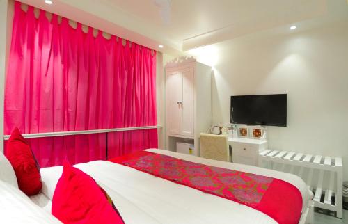 a bedroom with a large bed with pink curtains at The Pinky Villa - Heritage Boutique Suites- New Delhi in New Delhi
