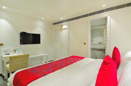 a bedroom with a large bed with red pillows at The Pinky Villa - Heritage Boutique Suites- New Delhi in New Delhi