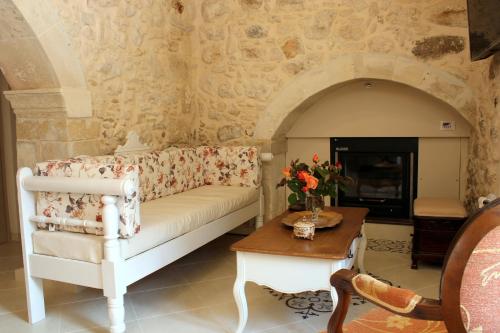 a living room with a couch and a table at Ioanna House in Gonia