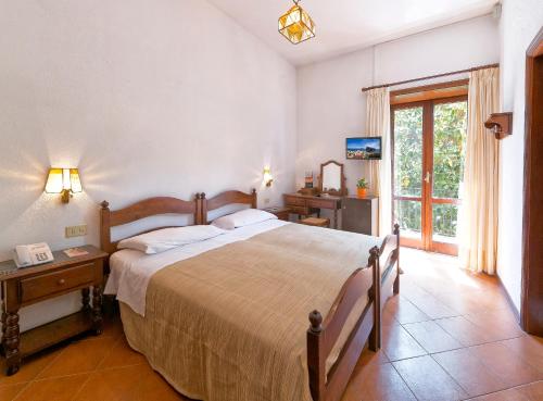 a bedroom with a large bed and a window at Hotel San Valentino Terme in Ischia