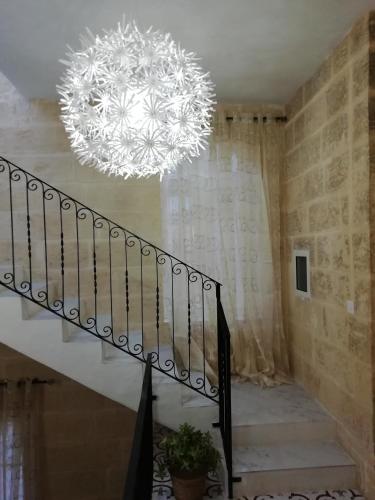 a chandelier in a room with a staircase with a stair at Sixty Two #1 in Victoria