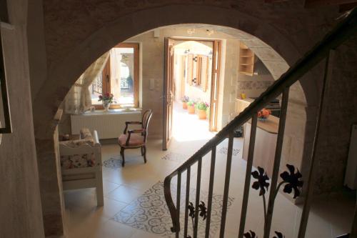 a hallway with an archway leading to a room at Ioanna House in Gonia