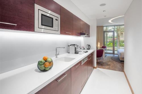 a kitchen with a sink and a microwave at Radisson Blu Hotel & Residence, Riyadh Diplomatic Quarter in Riyadh