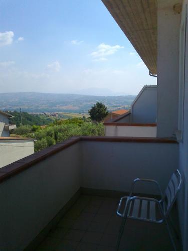 a chair sitting on a balcony with a view at Life Hotel in Ariano Irpino