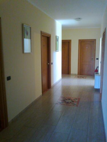 an empty room with two doors and a tile floor at Life Hotel in Ariano Irpino