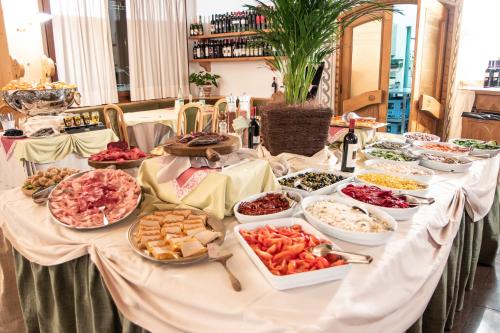 a table with a buffet of food on it at Hotel Santanton in Bormio