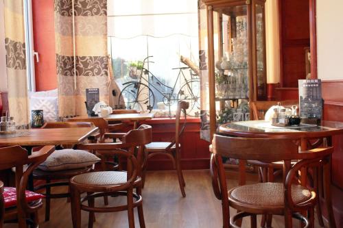 a restaurant with wooden tables and chairs and a window at Śnieżka in Krosno