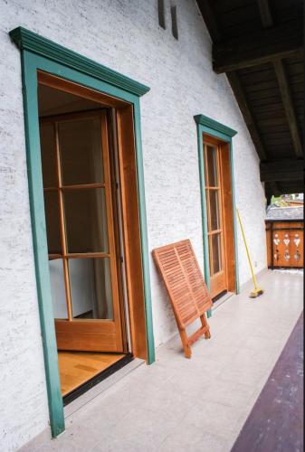 a wooden chair sitting on the outside of a building at Hallstatt Lake View House in Hallstatt