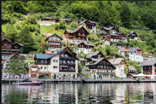 a village on the shore of a body of water at Hallstatt Lake View House in Hallstatt