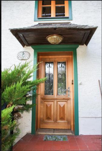 a wooden door on a white house at Hallstatt Lake View House in Hallstatt