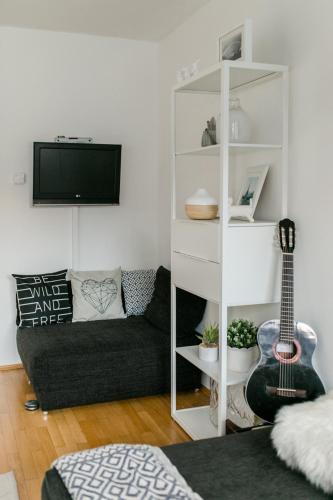 a living room with a couch and a guitar at Hallstatt Lake View House in Hallstatt