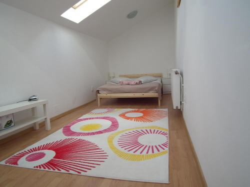 a room with a rug on the floor with a bed at Apartament BBB48 in Cluj-Napoca
