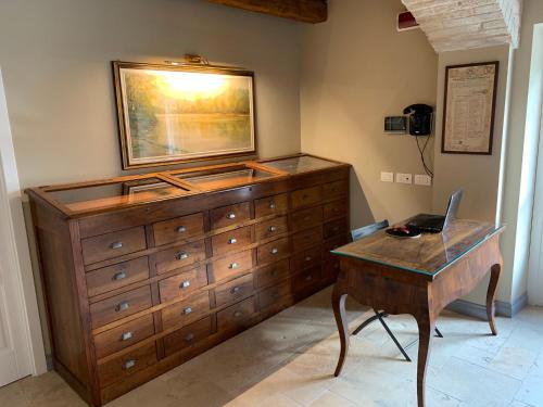 a bedroom with a dresser and a desk with a laptop on it at Villa Angela Country House in Fermo