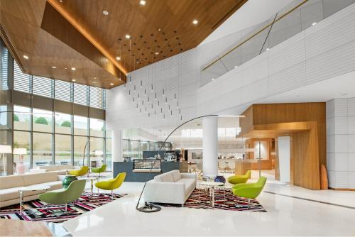 a lobby of a building with chairs and tables at Radisson Blu Hotel & Residence, Riyadh Diplomatic Quarter in Riyadh
