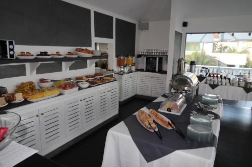 a kitchen with a table with food on it at Albachiara Hotel - Las Terrenas in Las Terrenas