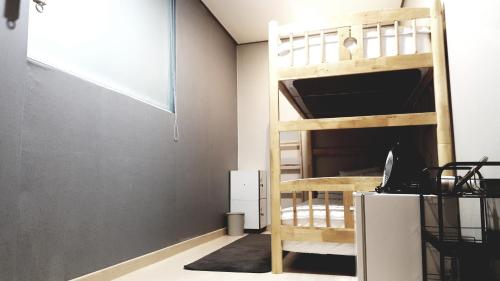 a bedroom with a bunk bed and a desk at O'guest in Haeundae in Busan