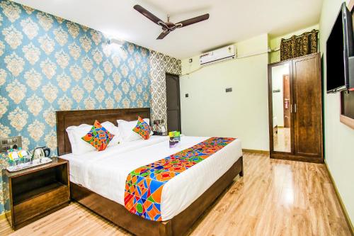 a bedroom with a large bed in a room at FabHotel Prince Park - Nr Sajra Fort in Vellore