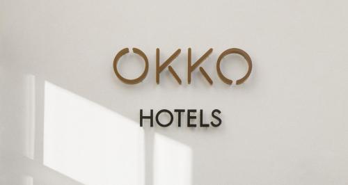 a sign for olympo hotels on a wall at OKKO Hotels Paris Gare de l'Est in Paris