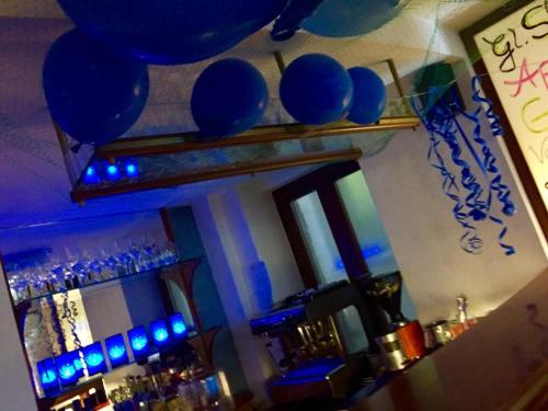 a bar with blue lights on a mirror at Hotel Krone in Pfullendorf
