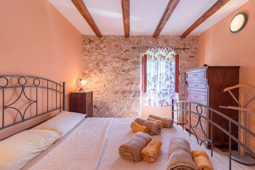 a bedroom with a large bed and a window at Country House Apartments in Pula