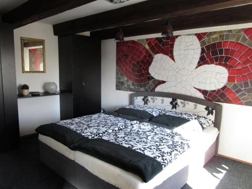 a bedroom with a bed with a mosaic wall at Holiday House Smetánek in Bruntál