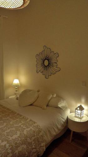 a bedroom with a bed with a flower clock on the wall at Casa Braancamp II - Chic & Sweet in Porto