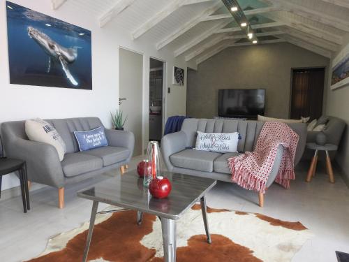 a living room with a couch and a table at Kango 10 in Hartenbos