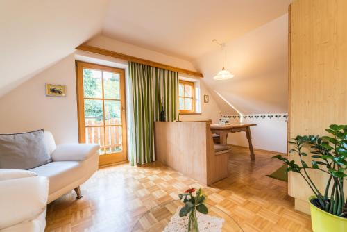 a living room with a couch and a table at Weingut Dietl in Riegersburg