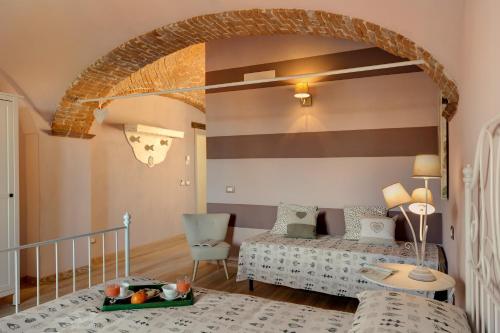 a living room with a bed and a table at Podere Demetra in Novi Ligure