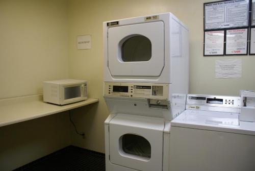 a laundry room with two machines and a microwave at Kawada Hotel in Los Angeles
