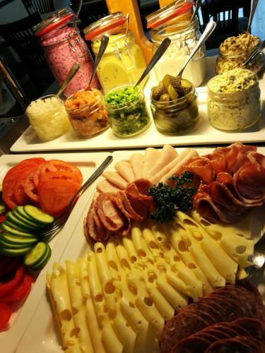 a buffet of different types of food on plates at Roosta Holiday Village in Elbiku
